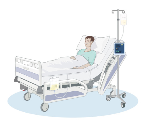 En patient ligger i en sjukhussäng på en uppvakningsavdelning.