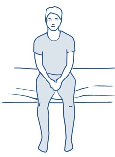 En person sitter p&aring; s&auml;ngkanten